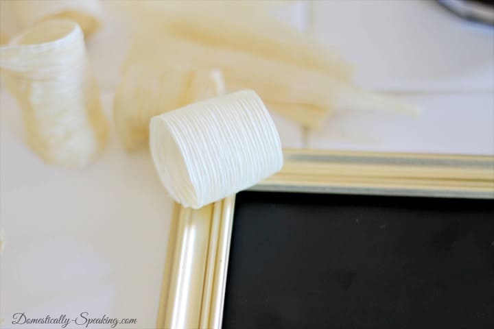 Thanksgiving craft for your Tablescape with Corn Husk and Chalkboard gluing corn husk to frame