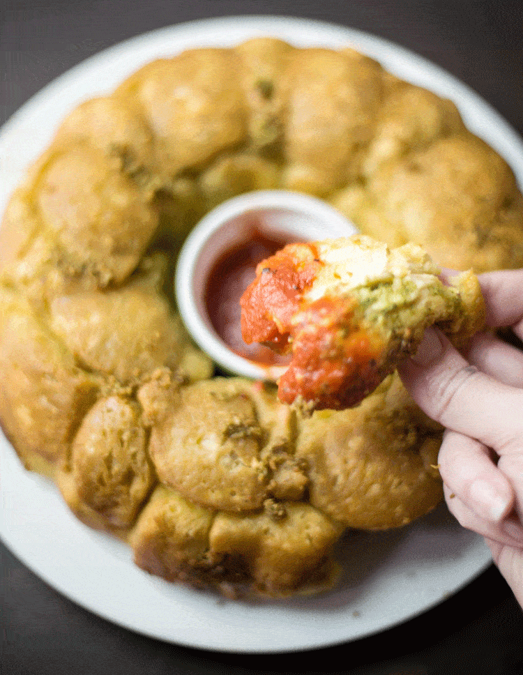 Pesto Monkey Bread dipped in marinara sauce Pesto Monkey Bread dipped in marinara sauce