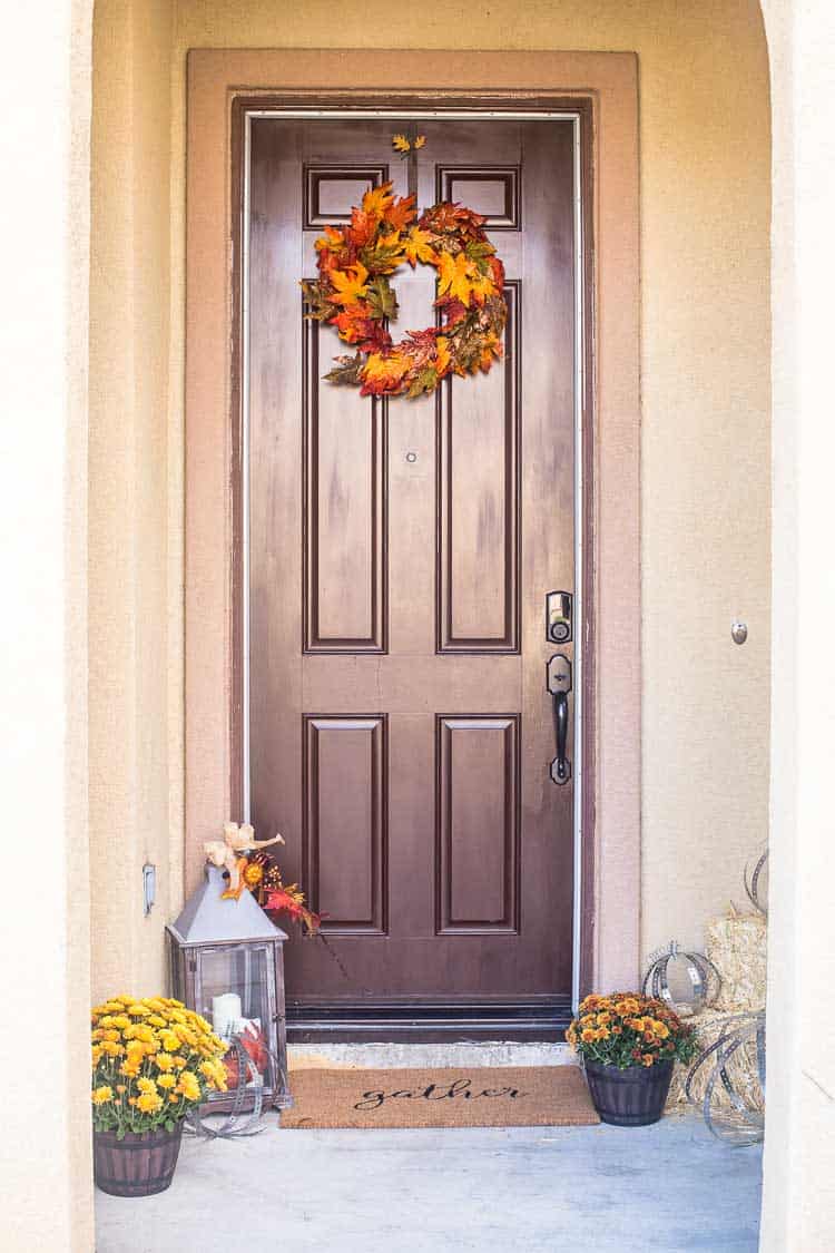 Rustic Industrial Autumn Porch with a Large Wood and Metal Lantern, Leaf Wreath, DIY Metal Pumpkins, Gather Doormat and lots of Fall Mums