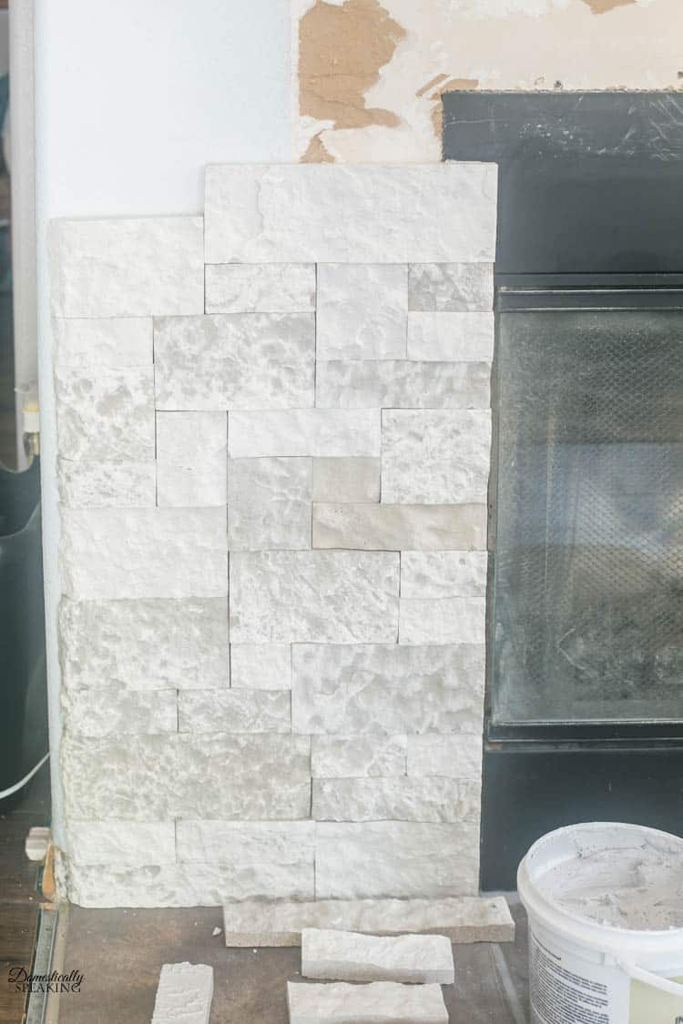 Putting the faux stone around the fireplace. Putting the faux stone around the fireplace.