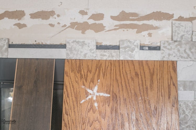 Holding up the faux stone while it dried over the fireplace opening. Holding up the faux stone while it dried over the fireplace opening.