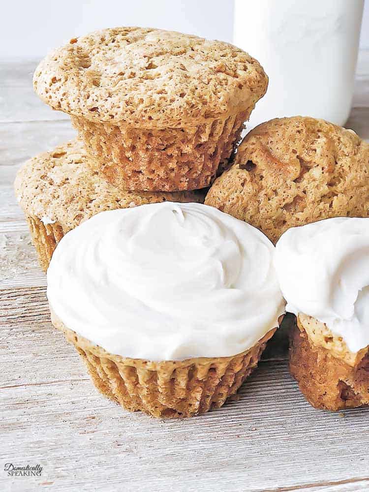 Simple Carrot Cake Cupcakes - they are moist and easy to make - perfect for Easter! Simple Carrot Cake Cupcakes on a wood board