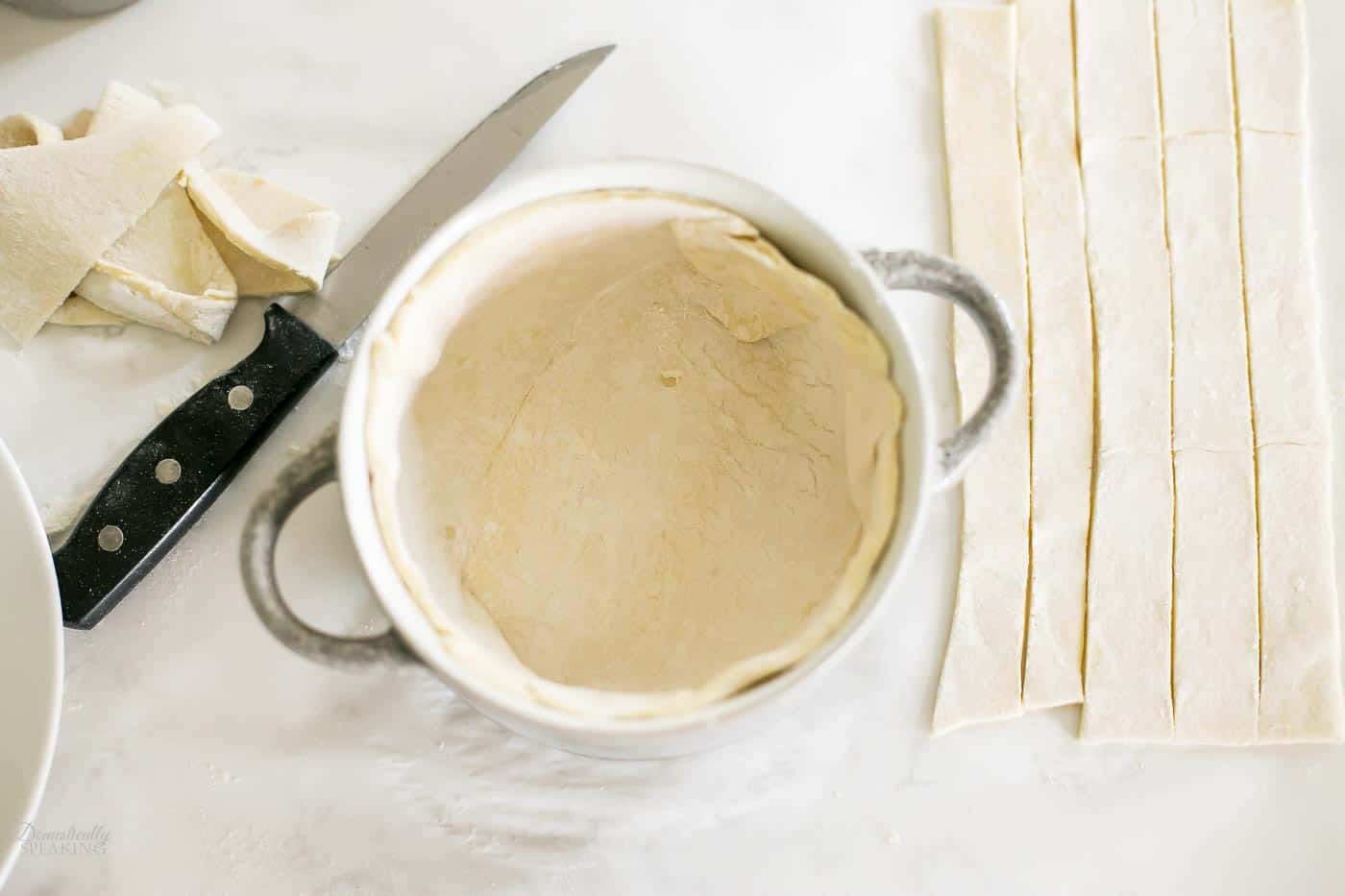 Cutting out puff pastry for the chicken pot pie using a plate. Cutting out puff pastry for the chicken pot pie using a plate.