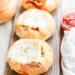 Lasagna Garlic Bread Bowls on a wooden board.