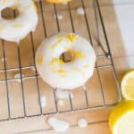 Lemon donuts on a cooling rack.