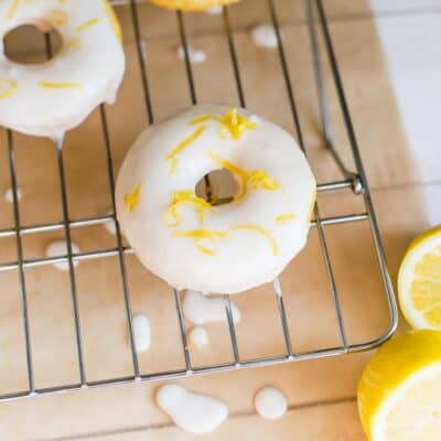 Lemon donuts on a cooling rack.