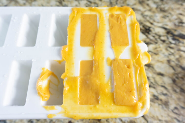 Adding pumpkin pudding pop to mold Adding pumpkin pudding pop to mold