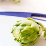 Cut off the top of artichoke
