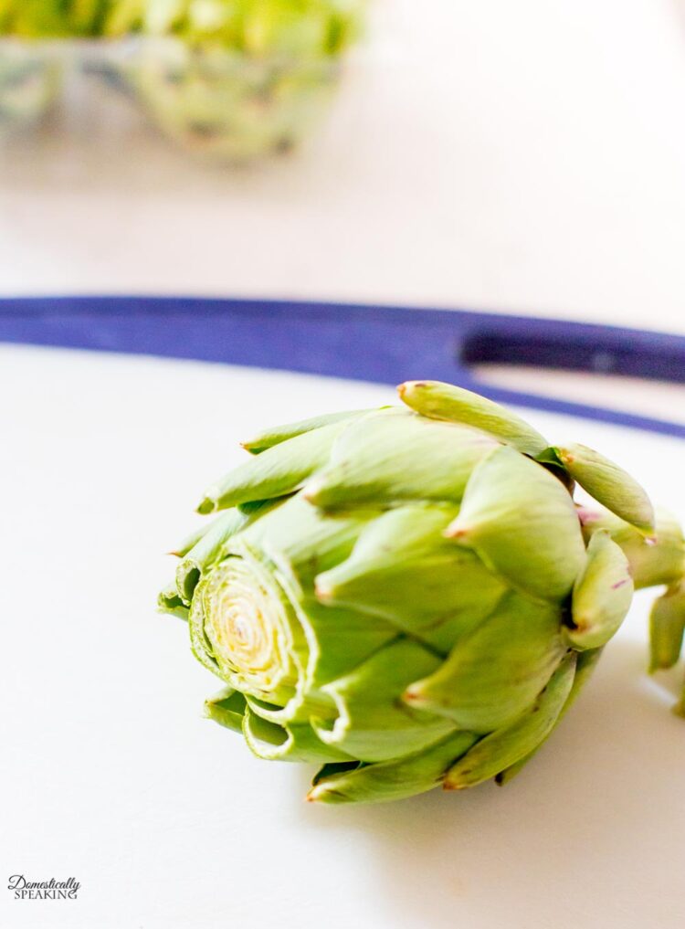 Cut off the top of artichoke