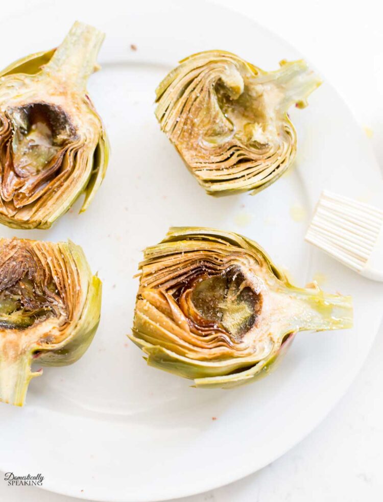 brushing cut artichokes before grilling
