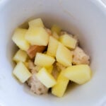 adding bread and apples to the mug