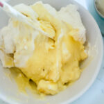 adding whipped cream to vanilla pudding