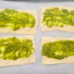 pesto spread on top of cream cheese for chicken pinwheels