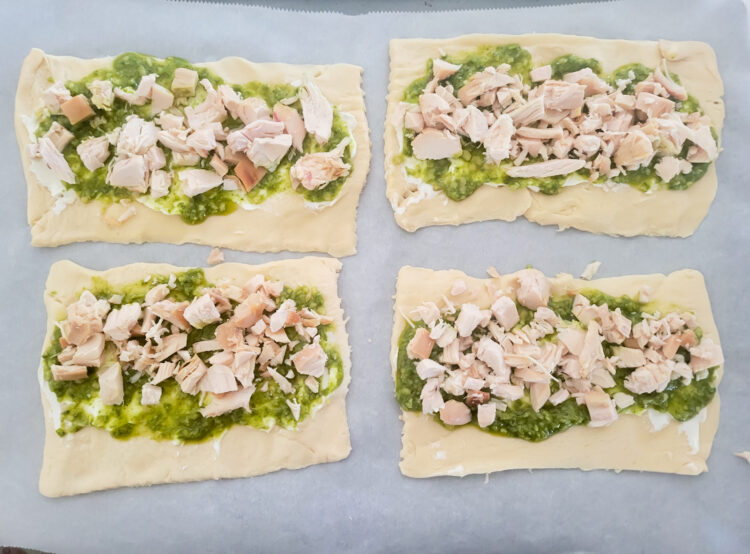 adding cooked chicken to the pinwheel crescent dough