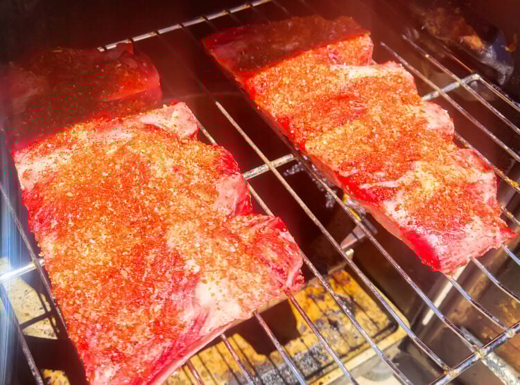 placing beef ribs on smoker