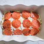 Adding pepperoni to the pizza dip