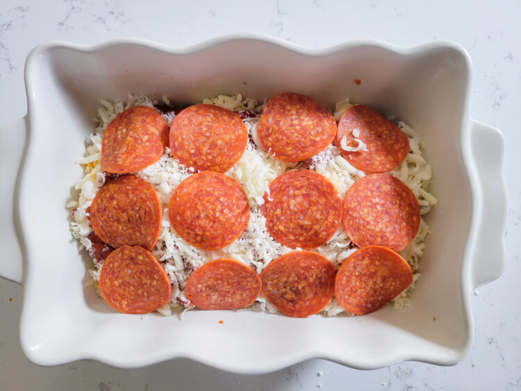 Adding pepperoni to the pizza dip