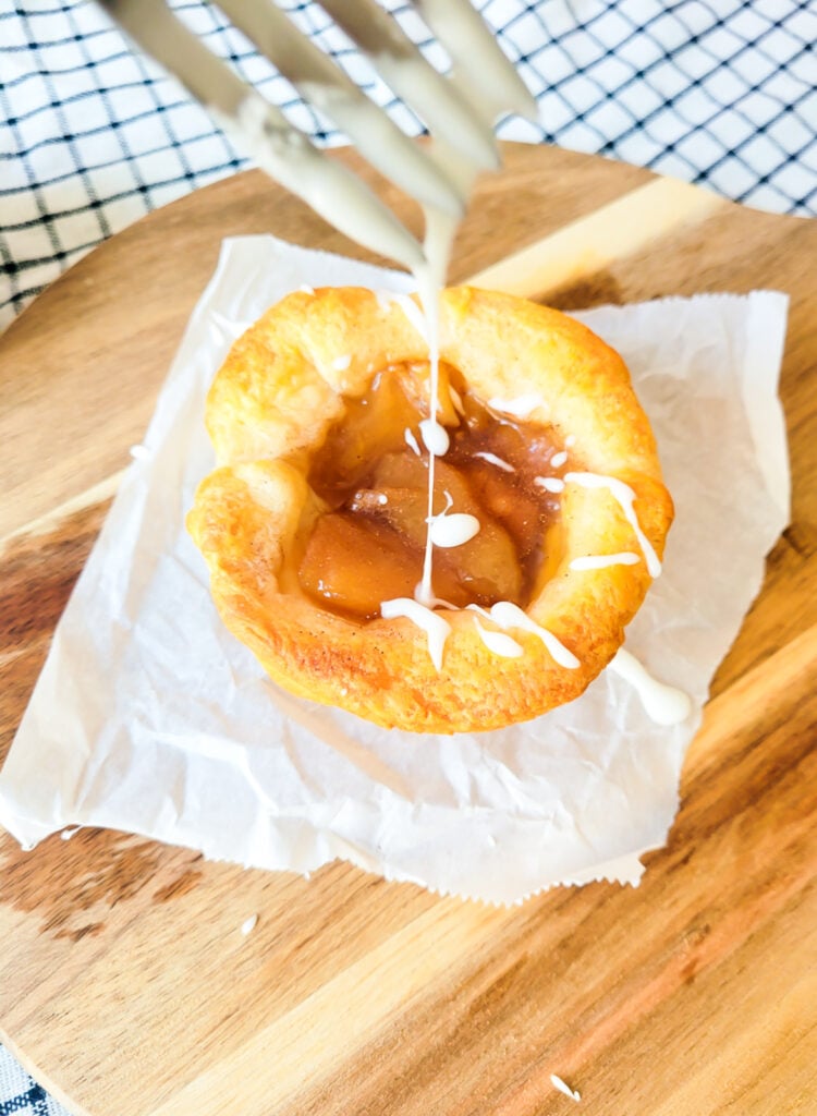 adding drizzle to apple crescent muffin